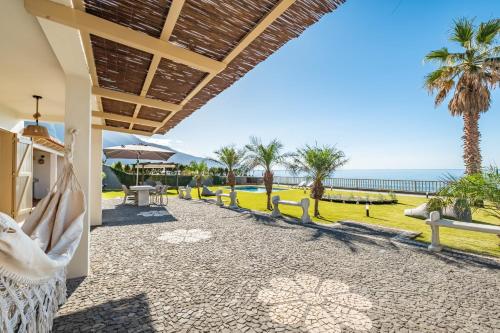 a resort with a view of the ocean at Hilani House by Homie in São Vicente