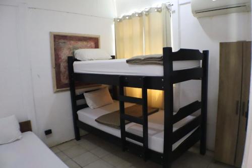 a couple of bunk beds in a room at Coconut Beach House in Playa Conchal
