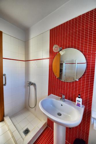 a bathroom with a sink and a shower and a mirror at La Villa De Rosses- Sana Halkidiki in Saná