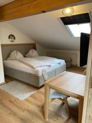 a bedroom with a bed and a table at Wengerhof "Urlaub im Gasteinertal" in Dorfgastein