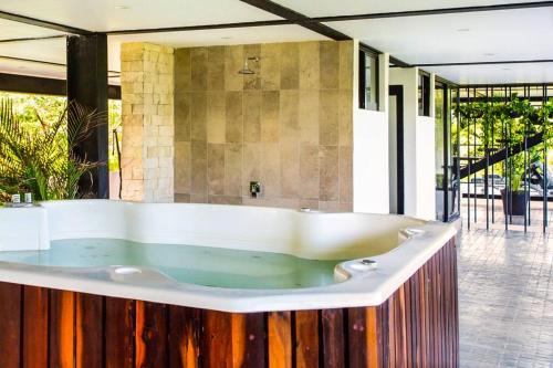 a large bath tub in a room with at 3BR Penthouse with Rooftop Pool Near Centro in Tulum