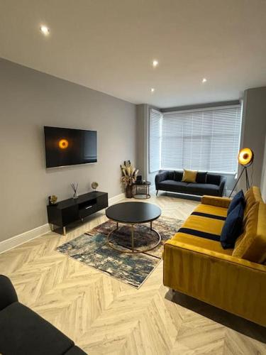 a living room with a couch and a table at Sea Breeze house in Lincolnshire