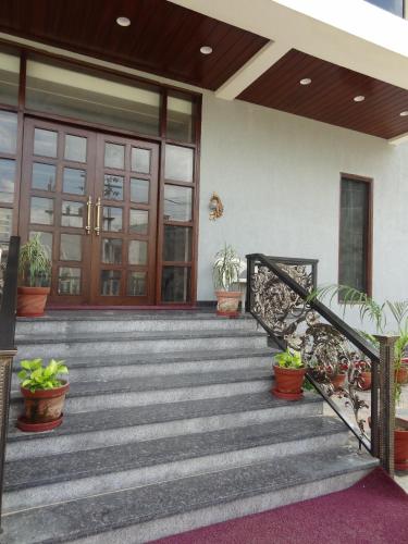 a front porch of a house with potted plants at Atalchhatra Luxury Boutique Hotel in Jaipur