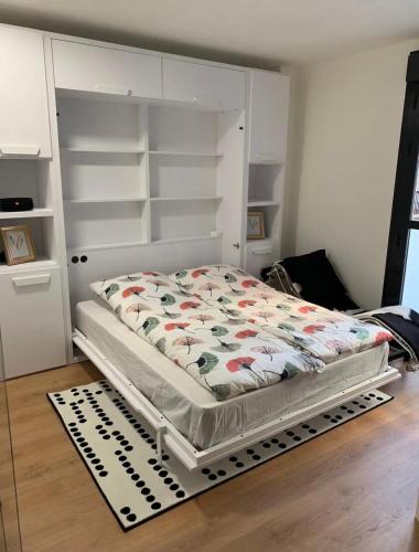 a bed in a room with white shelves at Luxury Apartment in Fuengirola