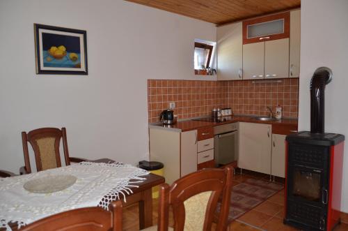 a kitchen with a table and a stove at Apartments Radingturs in Žabljak