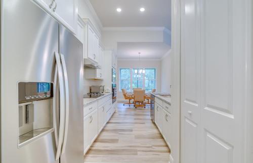 a kitchen with white cabinets and a refrigerator at Hernando Home 12 Mi to Crystal River! in Hernando