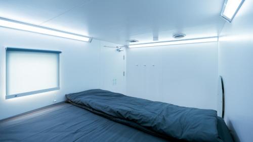 a bed in a room with a window at Bobopod Kota Lama, Semarang in Semarang