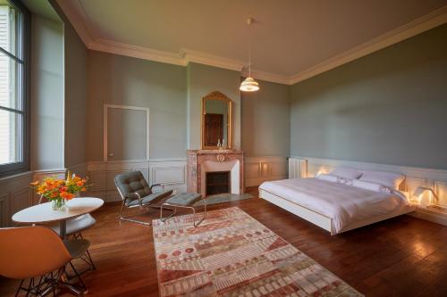 a bedroom with a bed and a fireplace at Château de Sibra in Lagarde