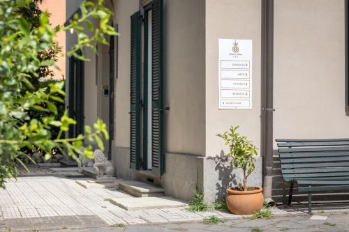 a plant sitting next to a building with a bench at Palazzo Dasso in Viterbo