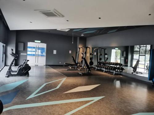 a gym with treadmills and exercise bikes in a room at Imanie Hstay Southvillecity - Moslim friendly in Kampong Tangkas