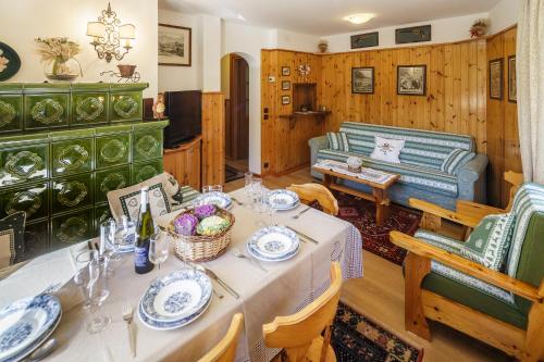 a living room with a table and a couch at CiasaToa in Cortina dʼAmpezzo