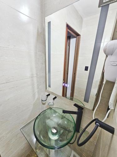 a glass sink in a bathroom with a mirror at Las Victorias Suites Bariloche in San Carlos de Bariloche