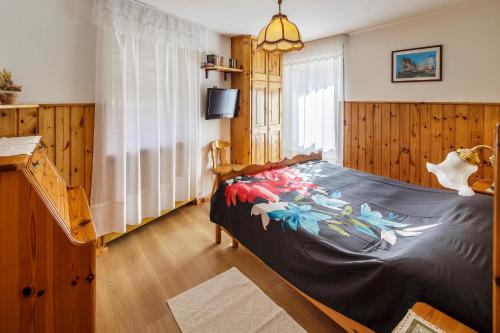 a bedroom with a bed with a colorful blanket at CiasaToa in Cortina dʼAmpezzo