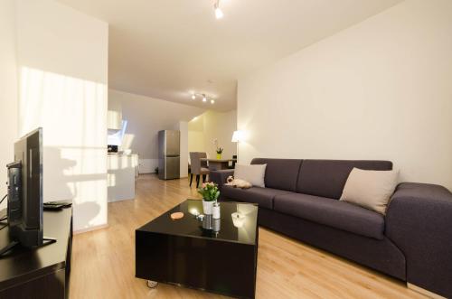 a living room with a couch and a table at Pension Zličín in Prague