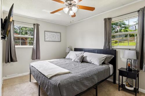 a bedroom with a bed with a ceiling fan at NEW 3BR-Pvt Swimming Pool-3 miles to Dollywood in Sevierville