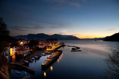 a view of a city with boats in the water at Casa del Borgo "Aria & Acqua" sul Lago Maggiore in Maccagno Inferiore