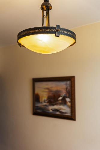 a light hanging from a ceiling with a picture at JazzPenzion in Čadca
