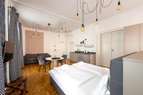 a bedroom with a bed and a living room at Designer Boutique Apartments Graz Trauttmansdorffgasse in Graz