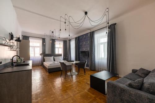 a living room with a couch and a table at Designer Boutique Apartments Graz Trauttmansdorffgasse in Graz