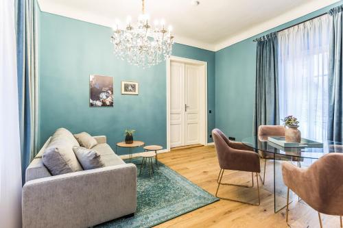 a living room with a couch and a table at Designer Boutique Apartments Graz Trauttmansdorffgasse in Graz