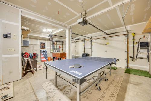 a ping pong table in the middle of a room at Lakefront Divide Cabin with Game Room! in Woodland Park