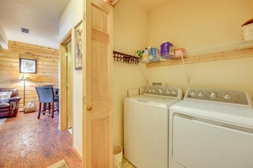 a laundry room with a washer and dryer in a cabin at Lakefront Divide Cabin with Game Room! in Woodland Park