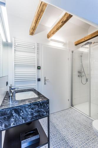 a bathroom with a sink and a shower at Designer Boutique Apartments Graz Trauttmansdorffgasse in Graz