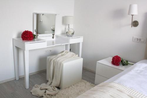 a white bathroom with a sink and a mirror at Apartments Villa Mantinela in Malinska