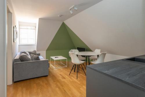 a living room with a couch and a table at Designer Boutique Apartments Graz Trauttmansdorffgasse in Graz