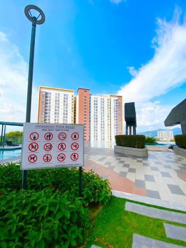a sign in front of some tall buildings at 2 Bedrooms Suites at Mesahill Nilai with Mall by D'KAY HOMES, near USIM KLIA in Nilai