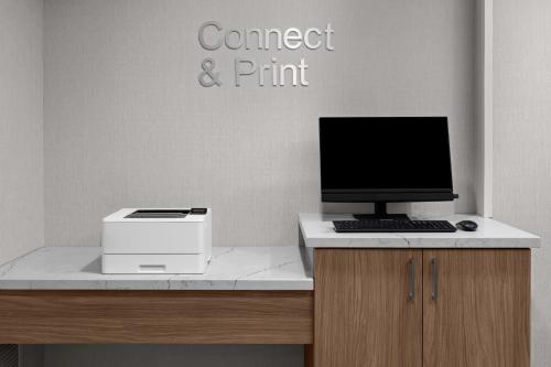a desk with a computer and a printer on it at Richfield Fairfield Inc in Richfield