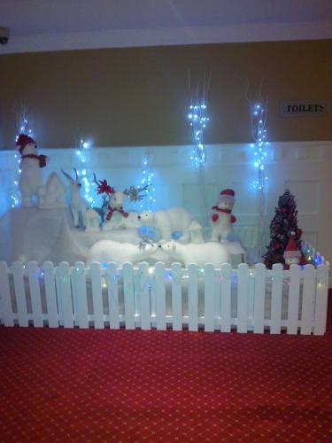 a room with a tub with snowmen and a white fence at Percy French Hotel in Strokestown