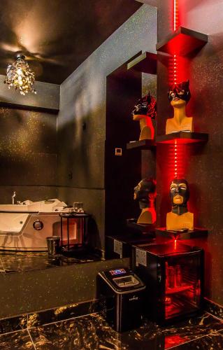 a room with a counter with some figurines on a shelf at Romeo Nights - Private Rooms - Adults Only in Bucharest