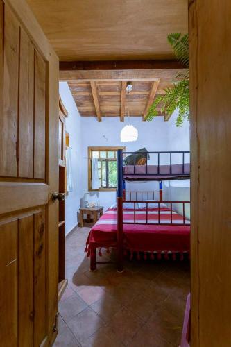 a bedroom with a red bed in a room at Natural Retreat & Pet-Friendly Escape in Miacatlán