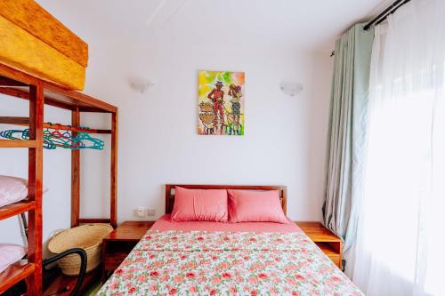 a bedroom with a bed and a poster on the wall at Jasiri Apartment, Beautiful ocean-view 2 bedroom home in Fumba Town in Dambani
