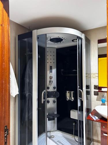 a glass shower in a bathroom with a sink at Sublime chalet à Ifrane avec piscine et parking gratuit in Ifrane