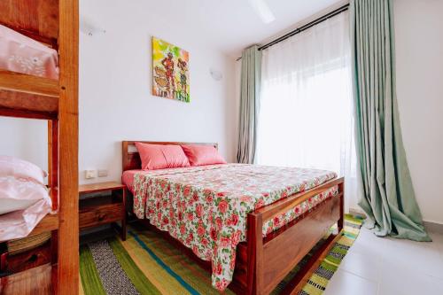 a bedroom with a bunk bed and a window at Jasiri Apartment, Beautiful ocean-view 2 bedroom home in Fumba Town in Dambani