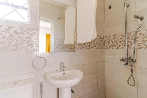 a bathroom with a sink and a shower at Saruni Homes in Nairobi