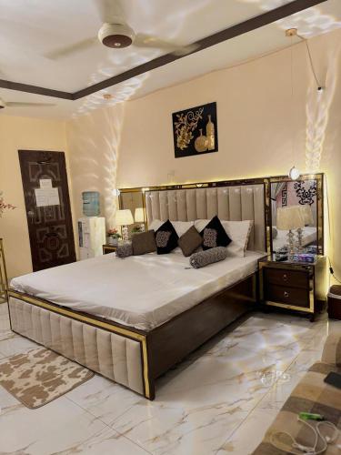 a bedroom with a large bed in a room at Charming Home banglow in Karachi