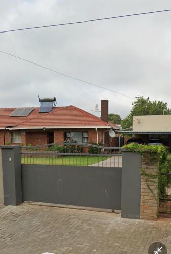a house with a gate and a fence at 20 Ernest self catering in Beaconsfield