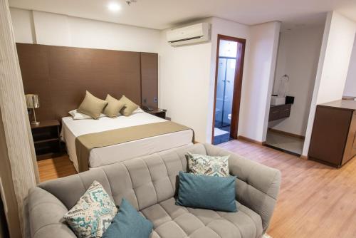 Postel nebo postele na pokoji v ubytování Olavo Bilac Hotel