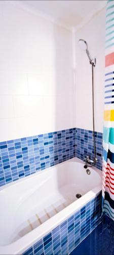 a bath tub in a bathroom with blue tiles at Casa Ridao-Habitación Buddha con vistas in Mojácar