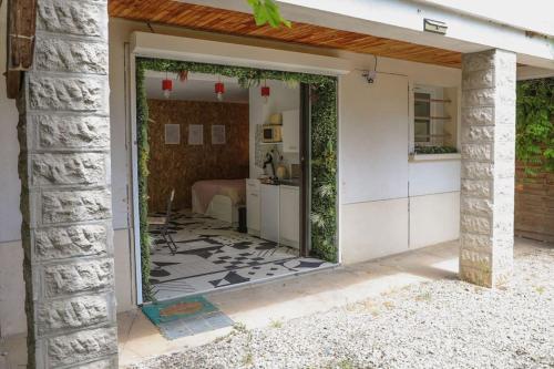 a home entrance with a door open to a bedroom at Appartement rez-de-chaussée et patio in Romans-sur-Isère