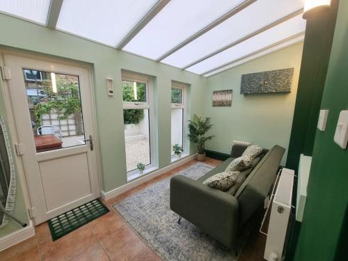 a living room with a couch and a window at Central Lancaster City Centre Terraced Gem in Lancaster
