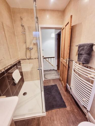 a bathroom with a shower and a toilet and a sink at Central Lancaster City Centre Terraced Gem in Lancaster