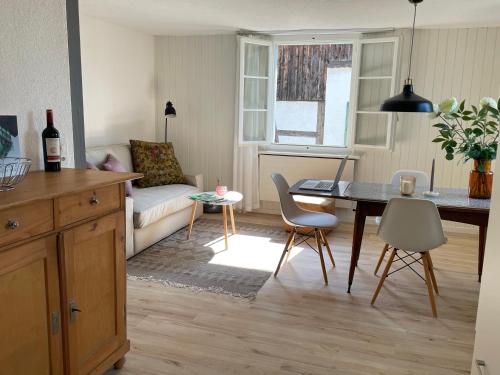 a kitchen and living room with a table and a couch at Charmante Wohnung im alten Dorfkern in Winterthur
