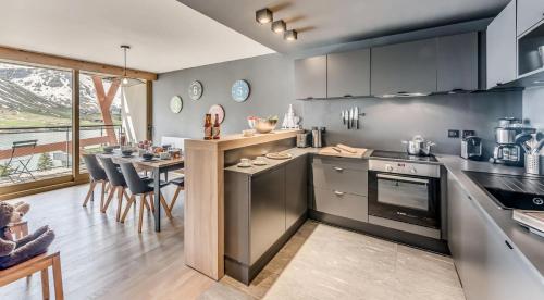 a kitchen with a table and a dining room at Résidence Phoenix - 5 pièces 8 personnes PREMIUM 4 MAE-0851 in Tignes
