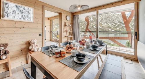 a dining room with a table and a large window at Résidence Phoenix - 5 pièces 8 personnes PREMIUM 4 MAE-0851 in Tignes