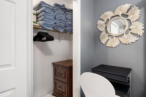 a bathroom with a white chair and a mirror at 2BD in Bartonville close to DT Peoria in Bartonville