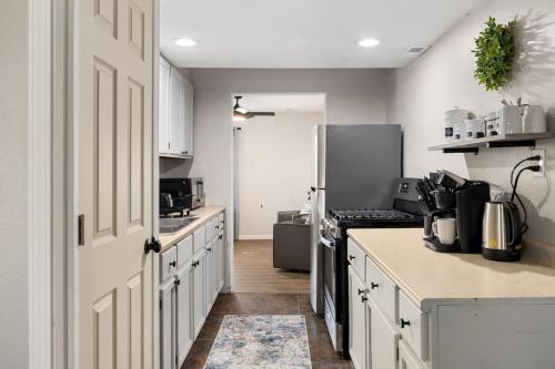 a kitchen with white cabinets and a refrigerator at Peaceful Park Living - 3BD 10mins to DT Peoria in North Pekin